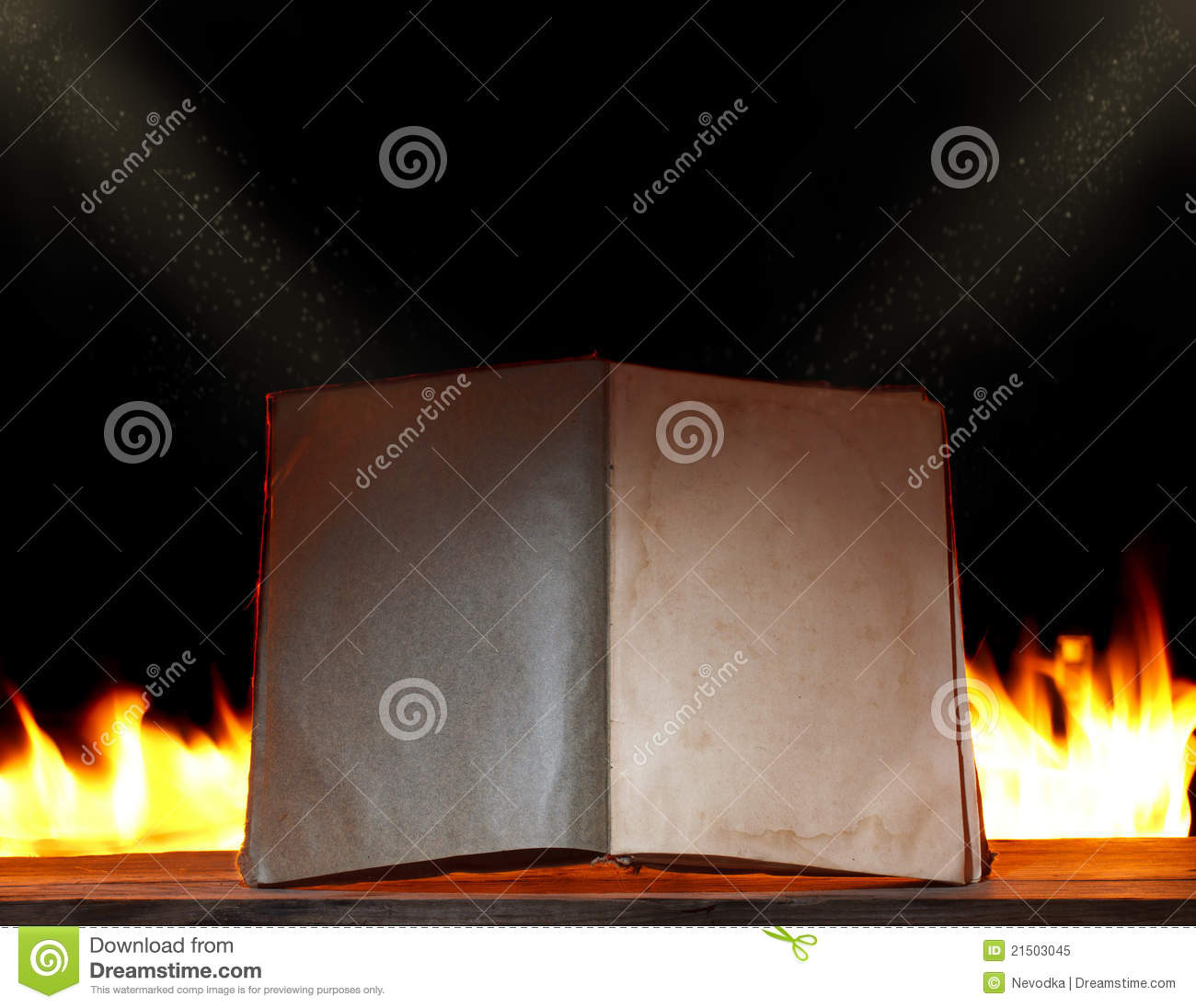 Open book in ambient light with fire